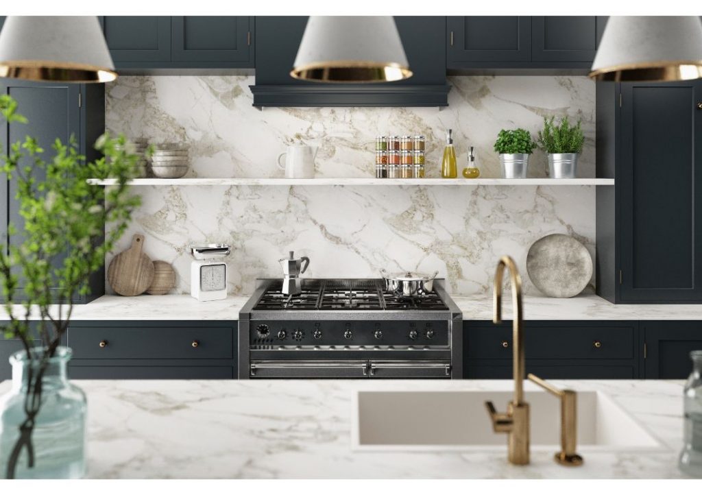 Kitchen with blue cabinets and white backsplash and countertops