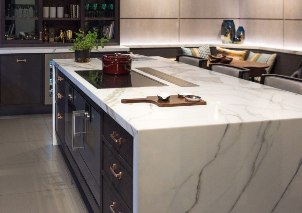 Marble kitchen island with dark cabinets